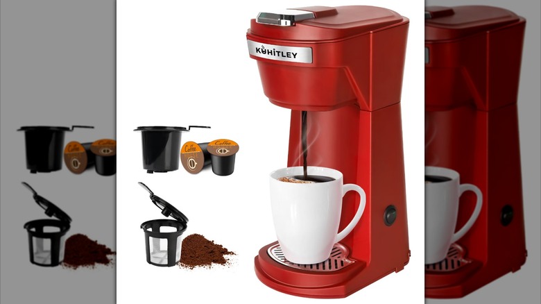 Product image of a small red coffee maker pouring coffee into a white mug.