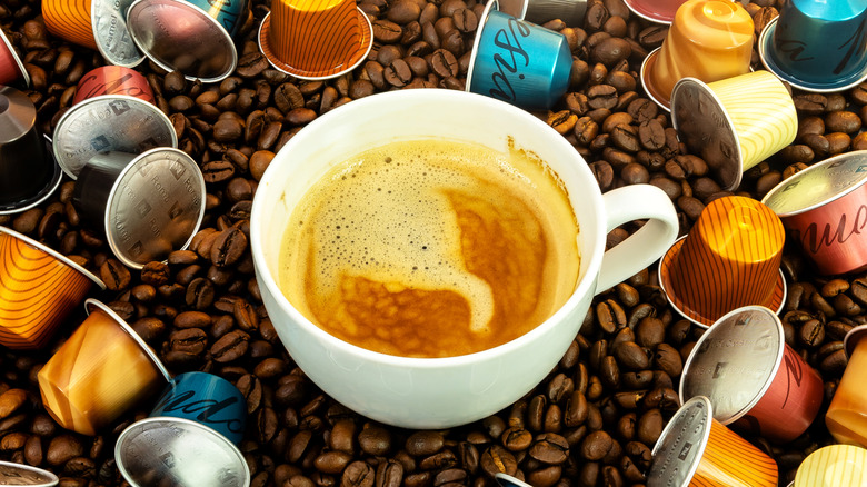 Fresh coffee surrounded by Nespresso pods