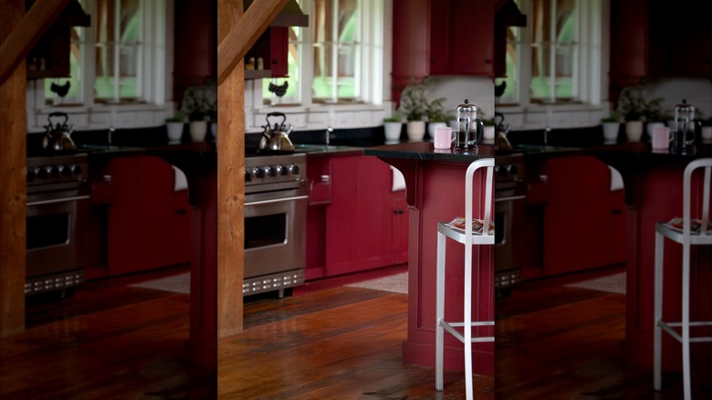 an elegant kitchen with burgundy walls