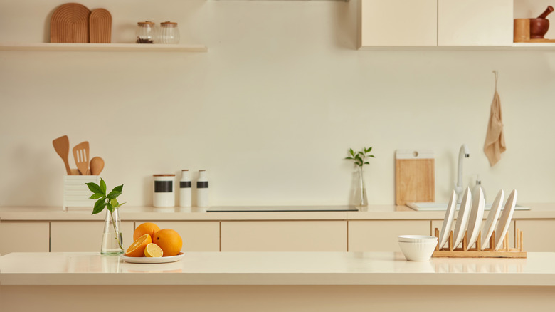 a kitchen counter with walls and cabinetry in a neutral beige