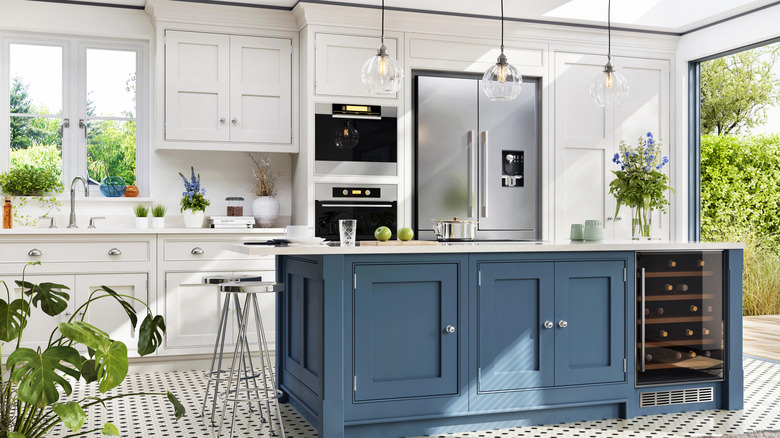 a beautiful kitchen with white cabinets and blue island