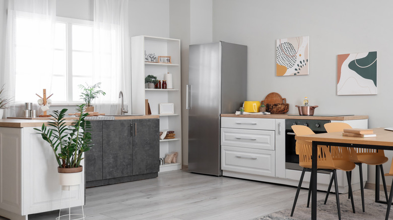 a modern kitchen with light grey walls