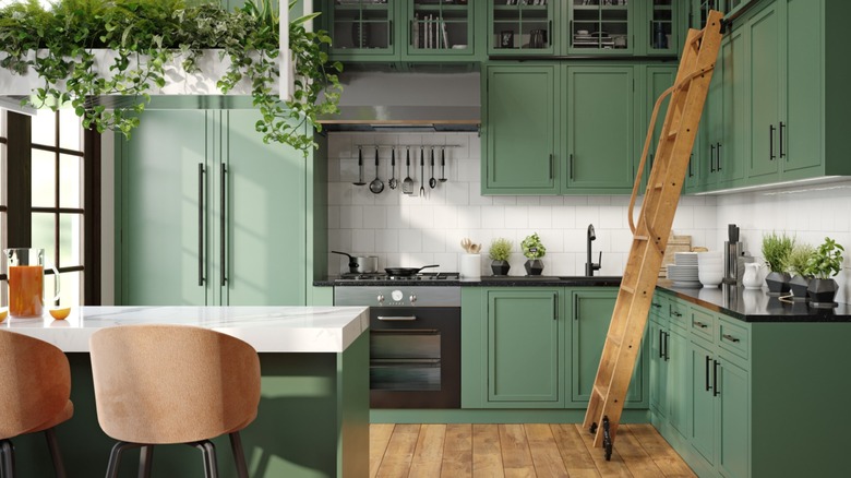a beautiful kitchen with green cabinets