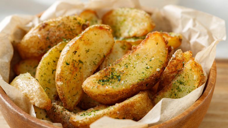 Potato wedges with herb garnish