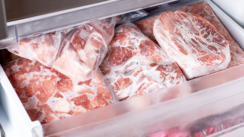 sealed bags of meat cuts in a freezer drawer
