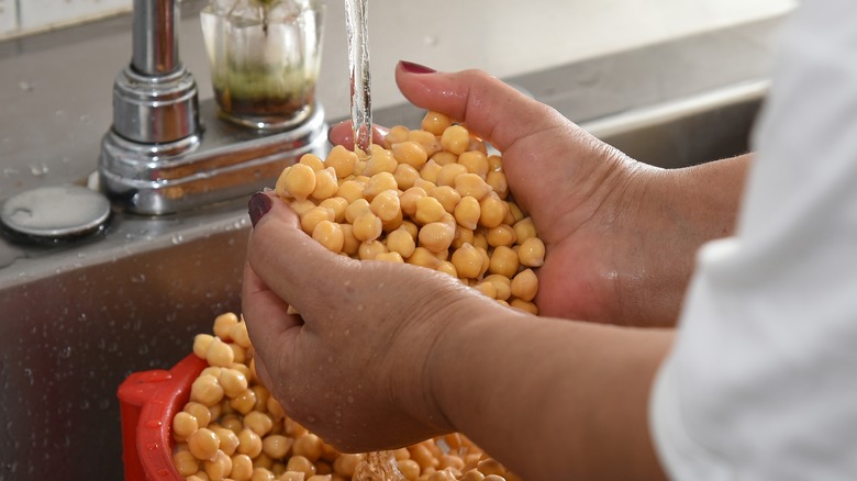 A woman washes chickpeas