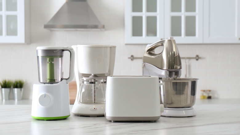 Small kitchen appliances lined up on a countertop