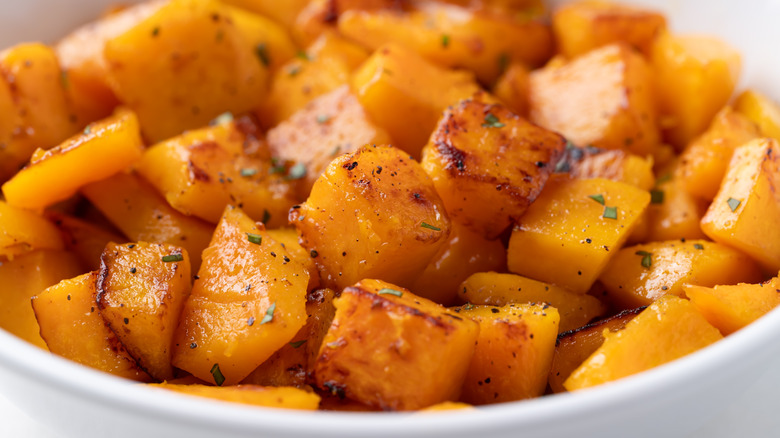 Cubes of roasted, seasoned butternut squash in a bowl