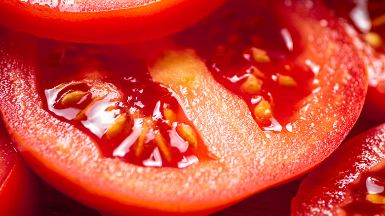 large ripe tomato sliced expose the seeds