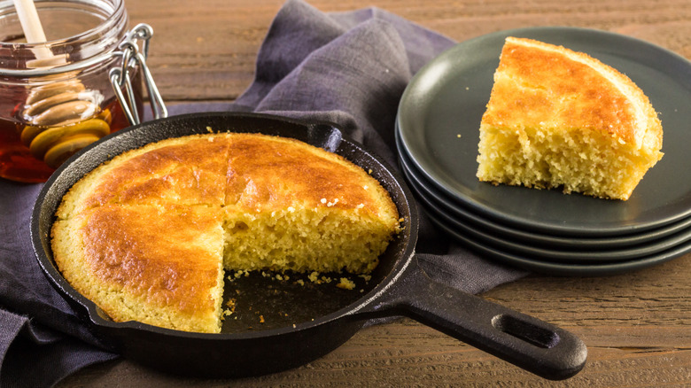 Spider cake in skillet with honey