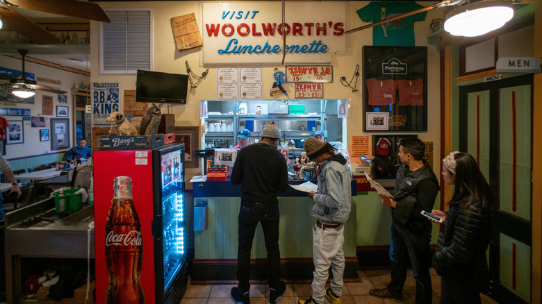 A line of customers at the counter inside Parkway Bakery