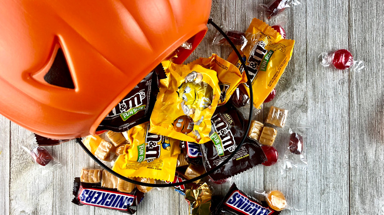 Halloween candy including M&Ms, Snickers, and caramels 