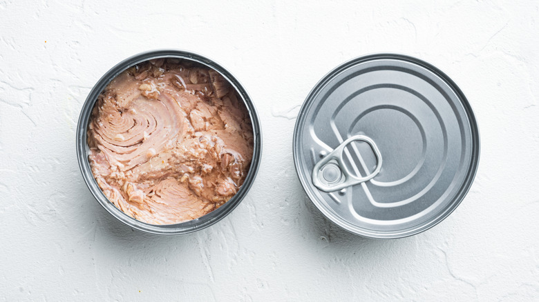Open and closed cans of tuna