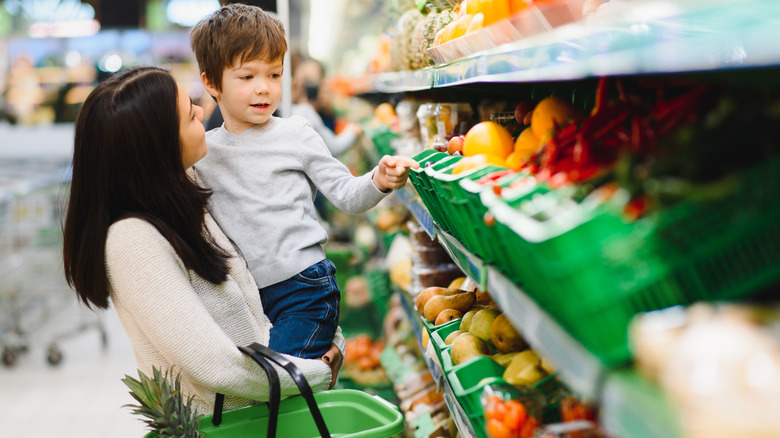 Child in store picks out fruit