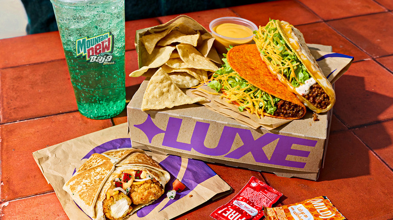 The Taco Bell Crispy Chicken Crunchwrap Slider Discovery Box and a Mountain Dew Baja Blast