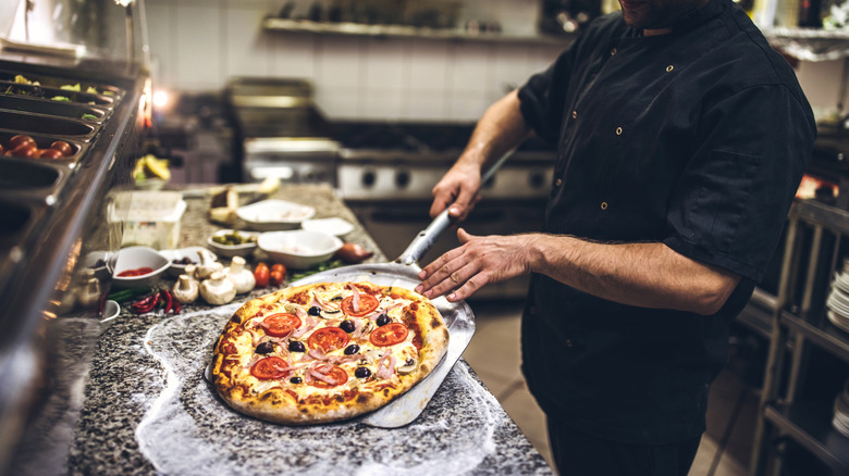 sliding pizza on to metal steel