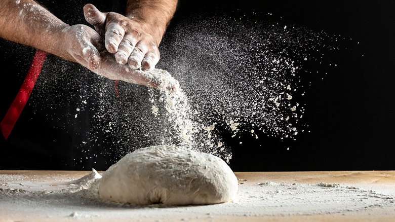 dusting flour making pizza dough