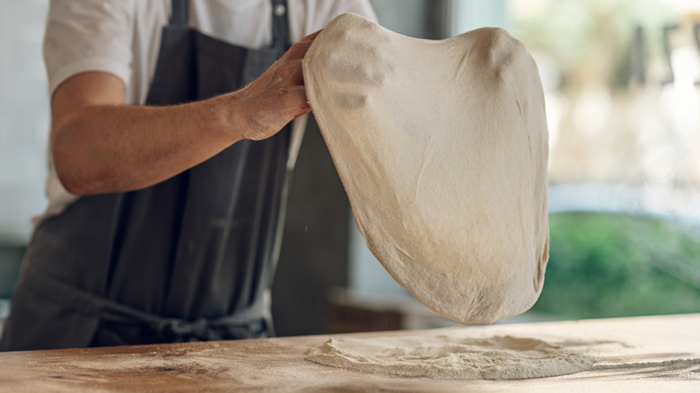 stretching homemade pizza dough