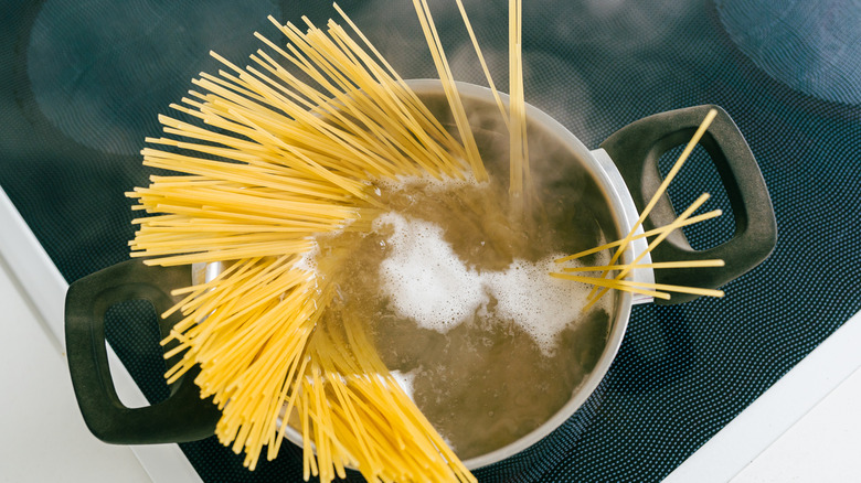 spaghetti in a pan of boiling water