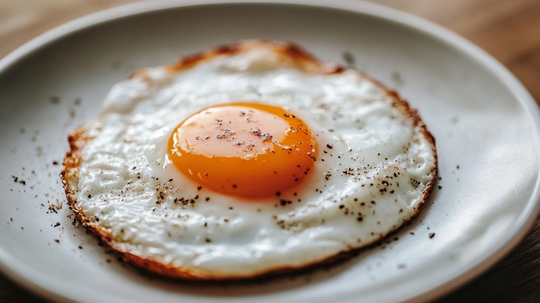 Fried egg with pepper on a plate