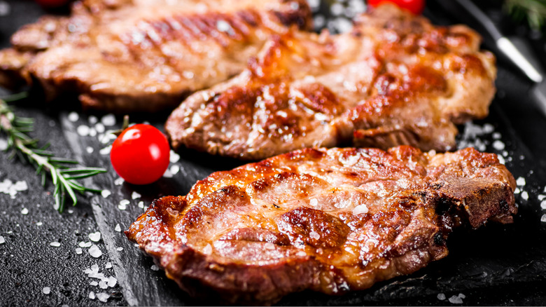 Pork steaks with cherry tomato, rosemary and salt