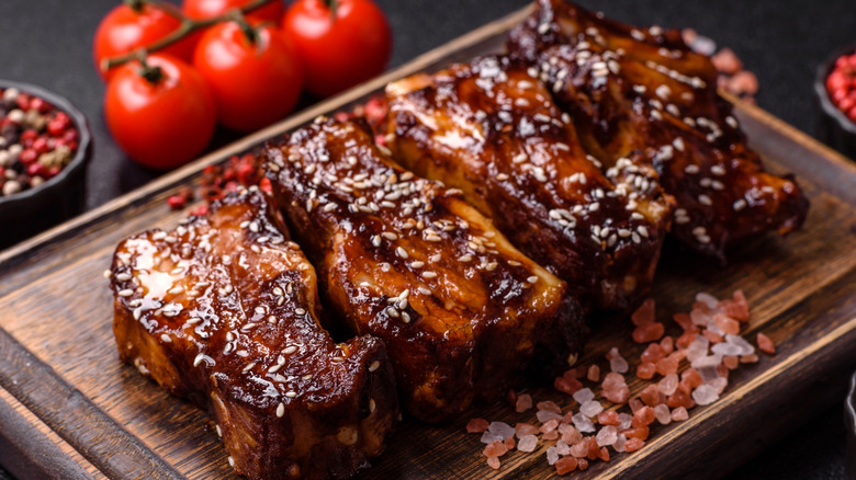 A row of perfectly seared pork steaks on a cutting board