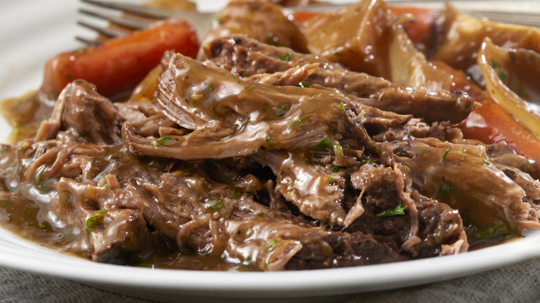 Pot roast on a plate with potatoes and carrots