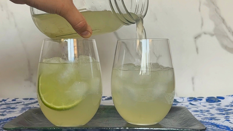 Pouring limeade into 2 glasses