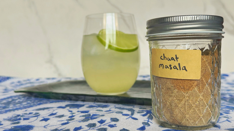 Jar of chaat masala in front of nimbu pani