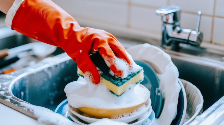 Person washing dishes in a sink