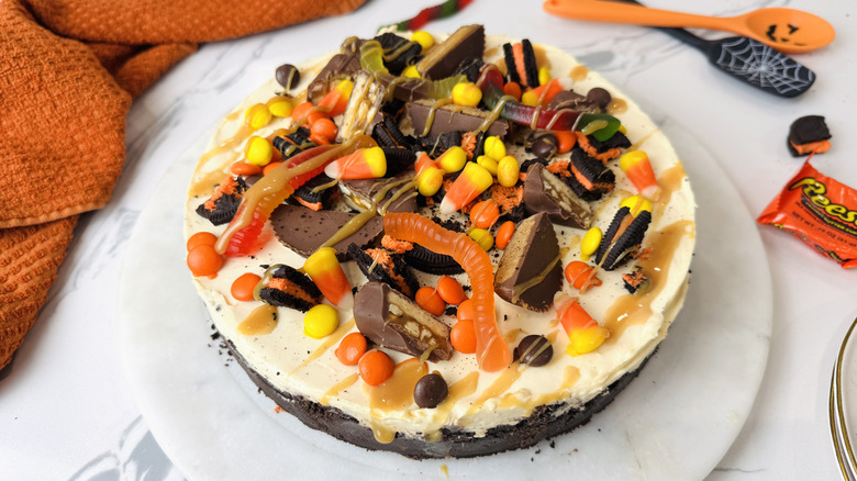 Halloween cheesecake topped with various pieces of candy