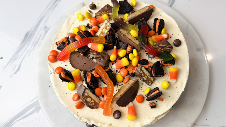 Cheesecake decorated with various Halloween candies