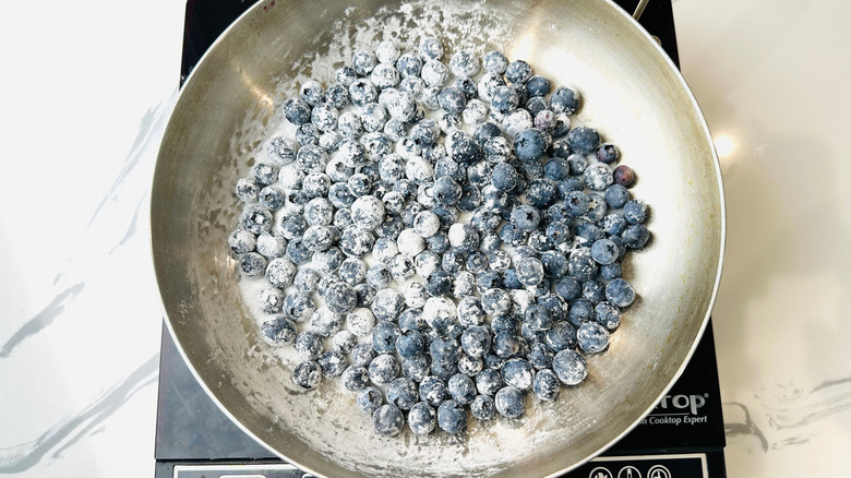 Blueberries and sugar in pan