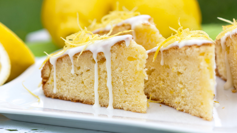 slices of lemon cake with frosting and lime zest