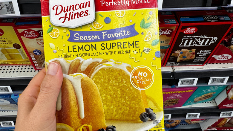 hand holding a boxed lemon cake mix