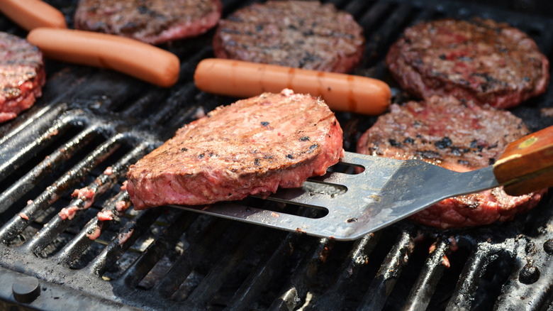 Flipping burger patty with spatula