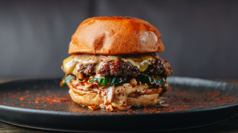 Burger with crisply crusted patty and loaded with toppings