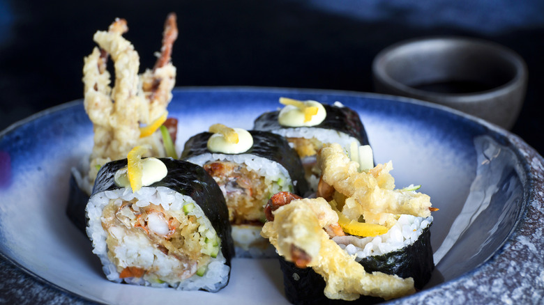 A spider crab roll, showing the legs of the crab poking out of the roll