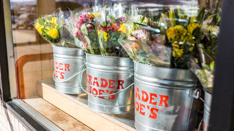 Tin buckets with Trader Joe's branding, holding flower bouquets