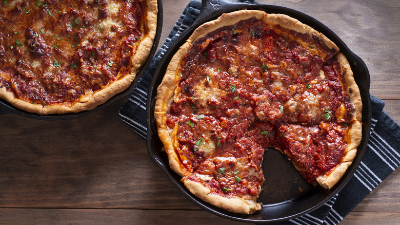 Two deep-dish pizzas in cast-iron skillets