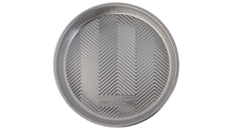A Nordic Ware round cake pan isolated on a white background