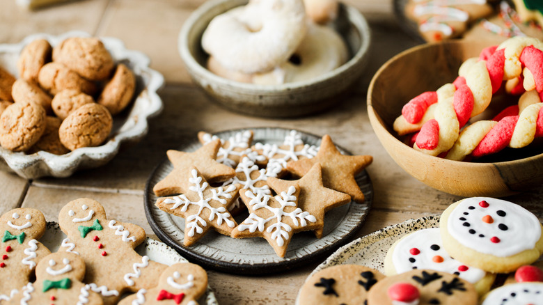 A variety of Christmas cookies displayed on plates and in bowls