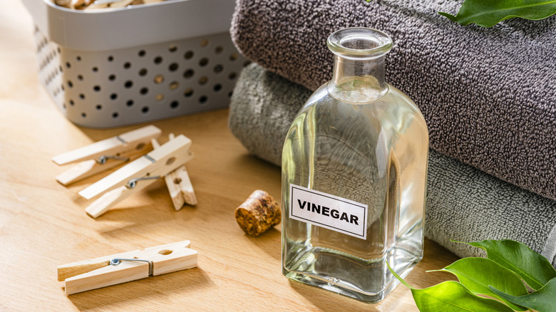 Vinegar bottle with folded towels, clothespins