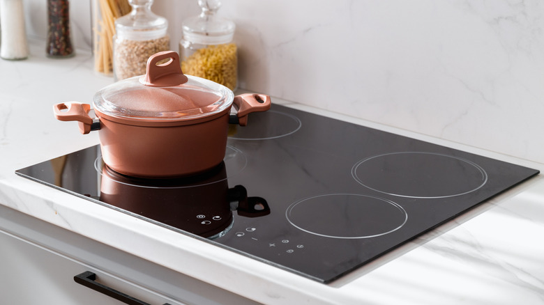 Black induction cooktop with copper pot