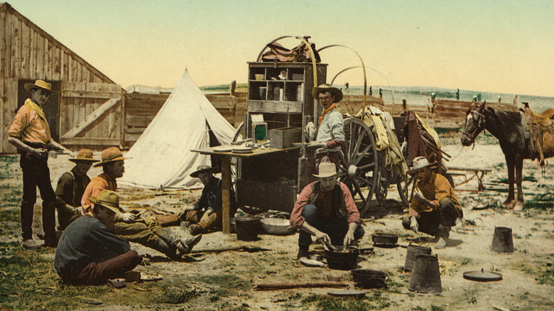 Colorized photo of a chuckwagon meal in the American West