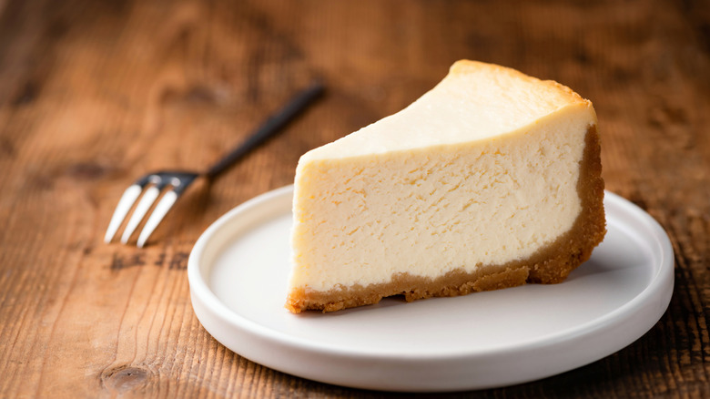 plated slice of cheesecake next to fork