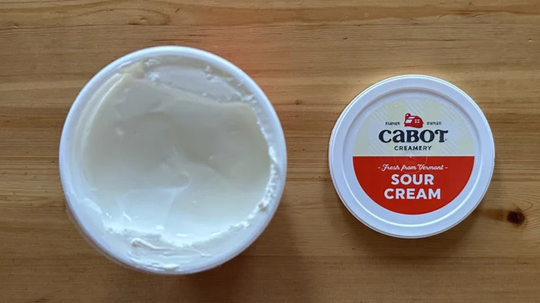 Cabot sour cream on a wooden table