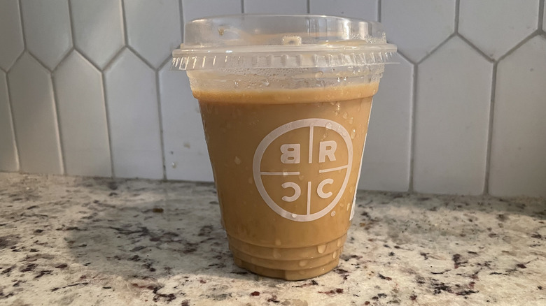 A vanilla iced latte from Black Rifle Coffee Company on a marble counter