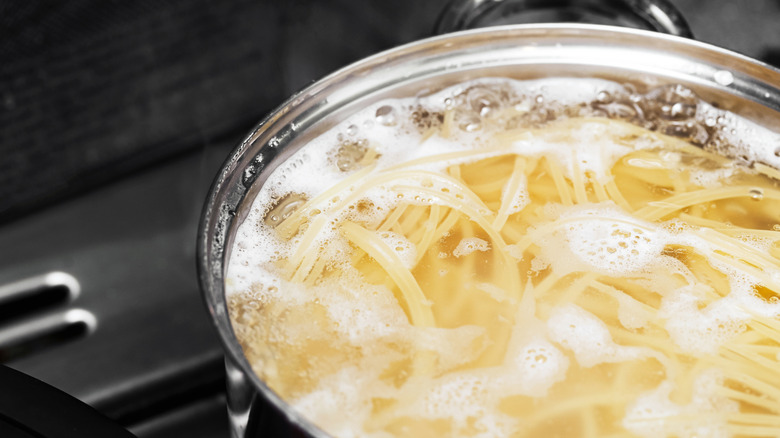 Cooking pasta in boiling water on a stove