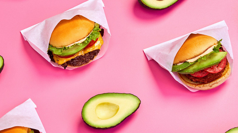 Hand holding Shake Shack Bacon Avocado Burger